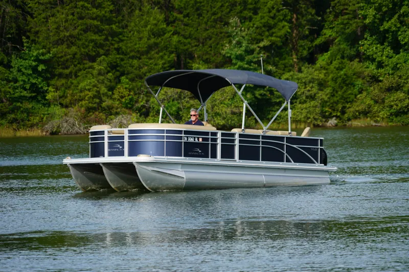 Slide: The Image of 2018 Bennington 22 SSX pontoon boat cruising on a scenic lake. - 4