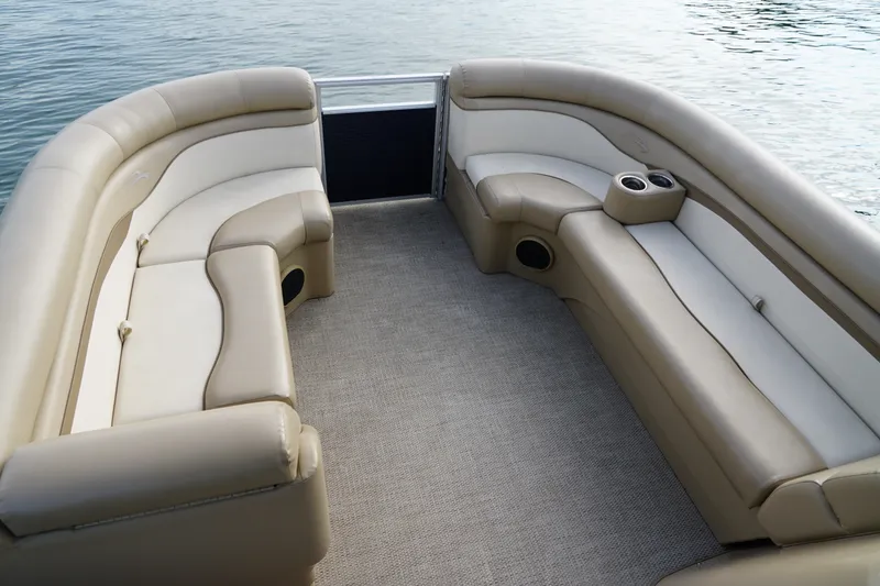 Slide: The Image of 2018 Bennington 22 SSX pontoon boat interior with beige seating and cup holders. - 14
