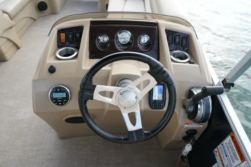 Slide: The Image of Steering console of a 2018 Bennington 22 SSX boat with gauges and controls. - 17
