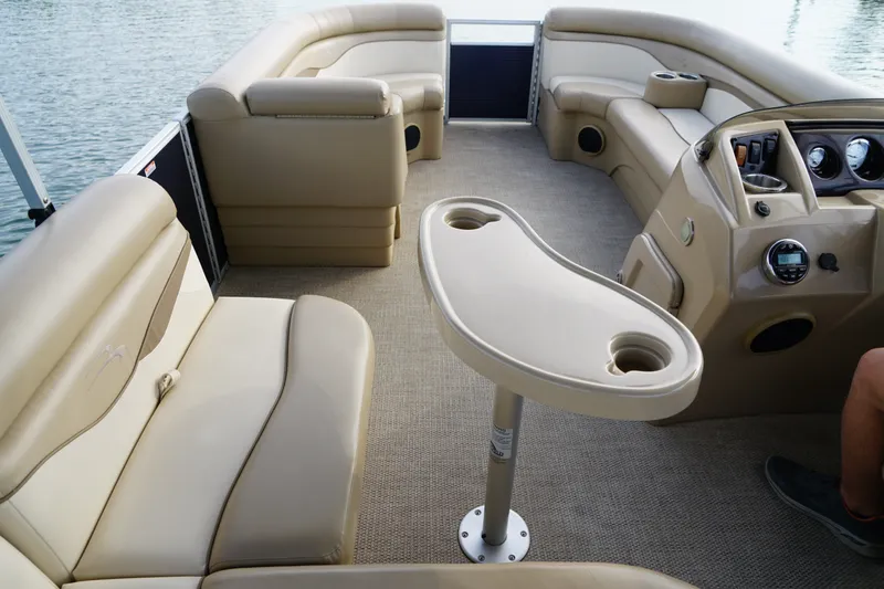 Slide: The Image of Interior of a 2018 Bennington 22 SSX pontoon boat with beige seating and table. - 13