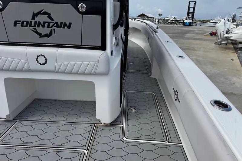 Slide: The Image of 2024 Fountain 34 Tournament Edition boat with sleek deck design at marina. - 23
