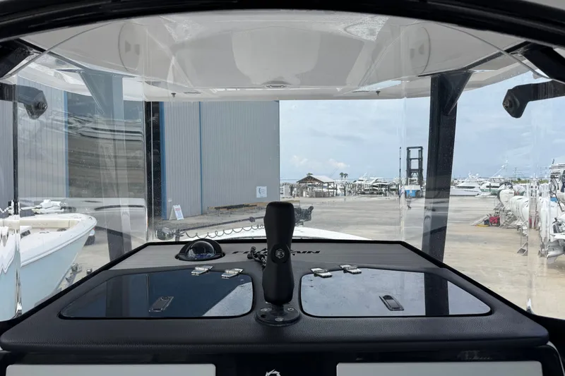 Slide: The Image of 2024 Fountain 34 Tournament Edition boat dashboard view at marina. - 19