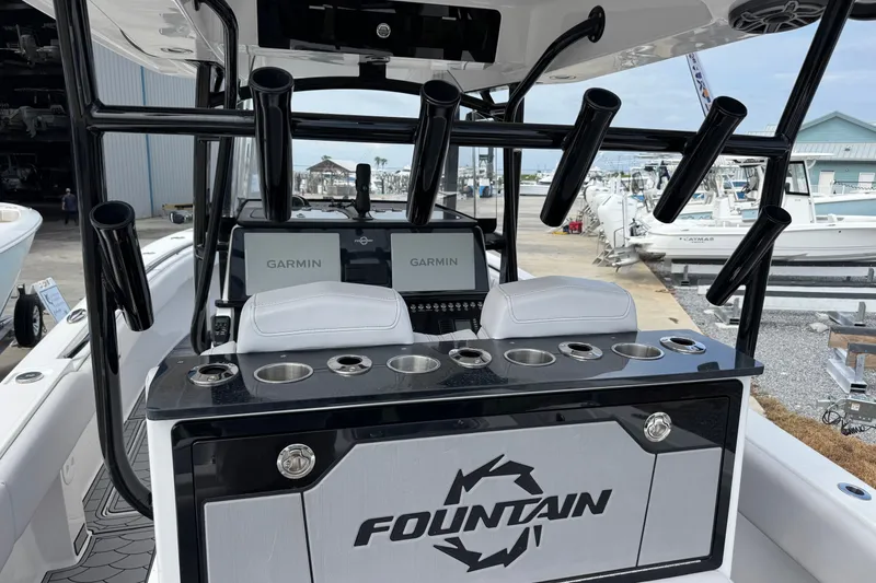 Slide: The Image of 2024 Fountain 34 Tournament Edition boat dashboard with Garmin displays and rod holders. - 22