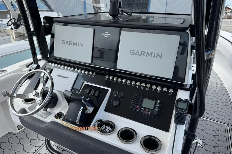 Slide: The Image of 2024 Fountain 34 Tournament Edition boat dashboard with Garmin displays and Mercury controls. - 17