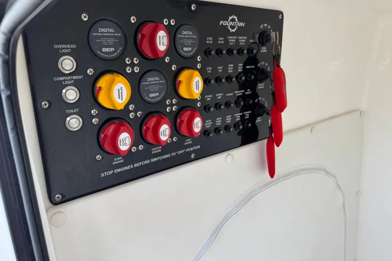 Slide: The Image of Control panel of 2024 Fountain 34 Tournament Edition boat with switches and keys. - 16