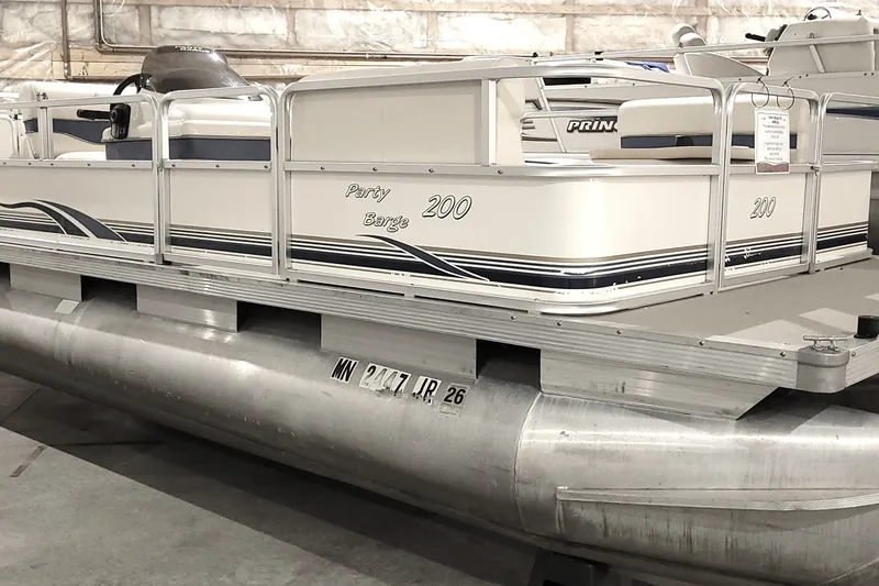 The Image of 2003 Sun Tracker Party Barge 200 pontoon boat in storage, side view. - 1
