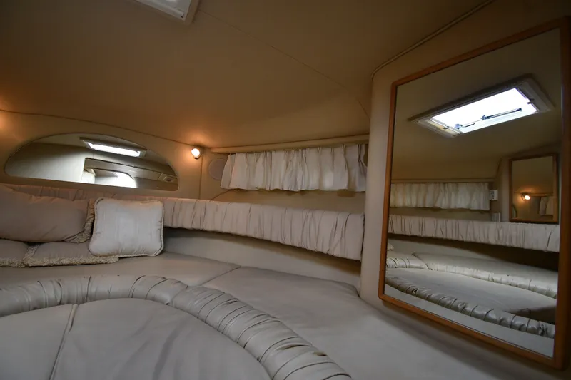 Slide: The Image of Interior cabin of 2000 Sea Ray 330 Express Cruiser with cozy seating and mirror. - 24
