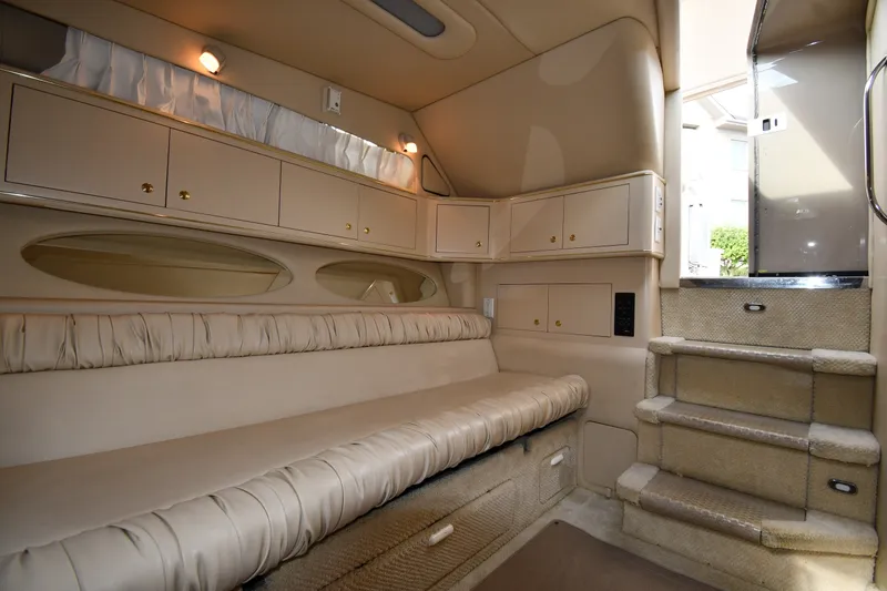 Slide: The Image of Interior of 2000 Sea Ray 330 Express Cruiser with beige seating and cabinetry. - 22