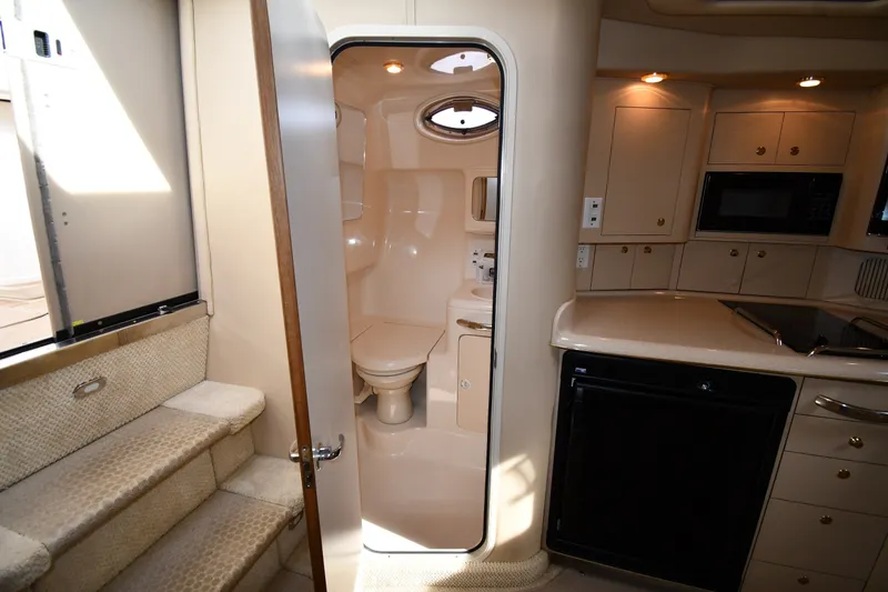 Slide: The Image of Interior of 2000 Sea Ray 330 Express Cruiser with kitchenette and bathroom. - 31