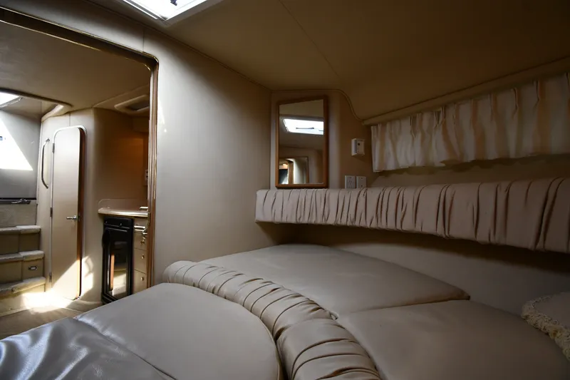 Slide: The Image of Interior of 2000 Sea Ray 330 Express Cruiser with cozy cabin and soft lighting. - 26