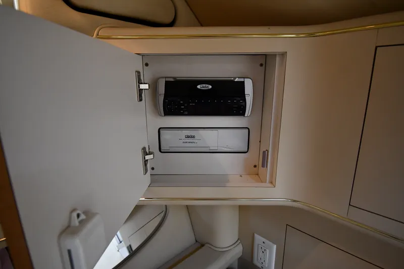 Slide: The Image of Open cabinet in 2000 Sea Ray 330 Express Cruiser with stereo system inside. - 33