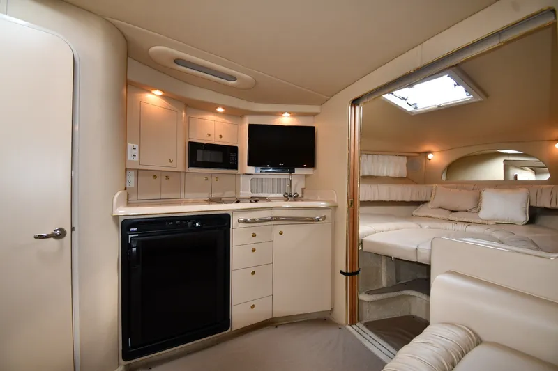 Slide: The Image of Interior of 2000 Sea Ray 330 Express Cruiser with kitchenette and cozy seating area. - 20