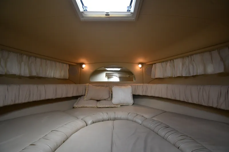 Slide: The Image of Interior cabin of 2000 Sea Ray 330 Express Cruiser with cozy seating and cushions. - 23
