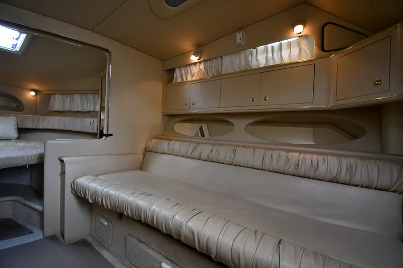 Slide: The Image of Interior of 2000 Sea Ray 330 Express Cruiser with beige seating and cabinetry. - 19