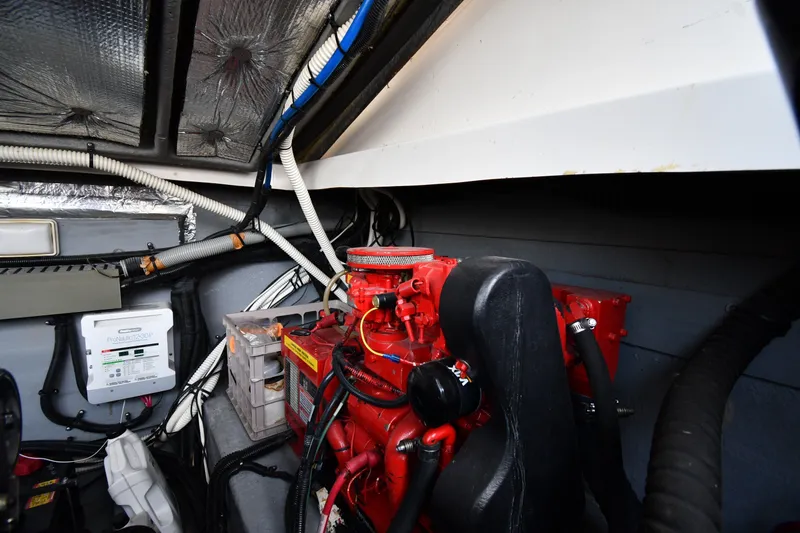 Slide: The Image of Engine room of a 2000 Sea Ray 330 Express Cruiser with visible red engine components. - 38