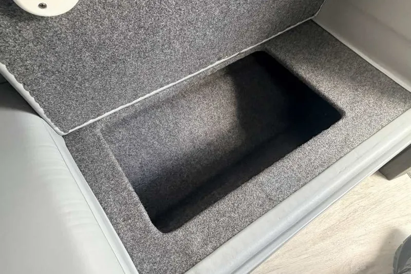 Slide: The Image of 2018 Formula 290 Sun Sport boat storage compartment with gray interior lining. - 38