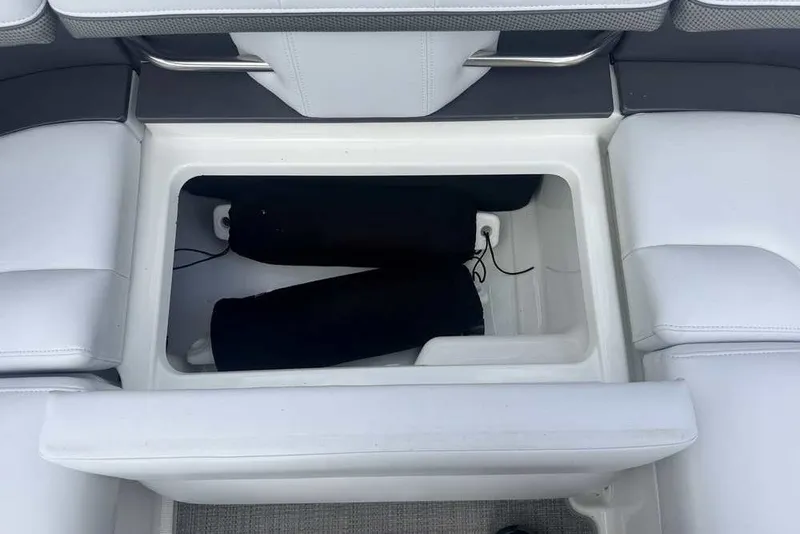 Slide: The Image of Storage compartment in 2018 Formula 290 Sun Sport boat with white seating. - 18