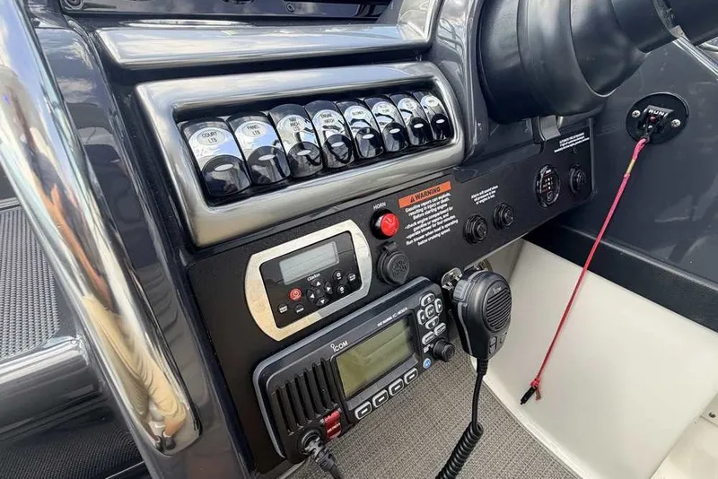 Slide: The Image of Control panel of a 2018 Formula 290 Sun Sport boat with various switches and communication devices. - 35