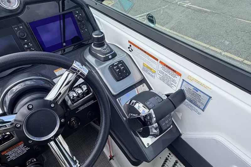 Slide: The Image of Control panel of a 2018 Formula 290 Sun Sport boat with steering wheel and throttle. - 34