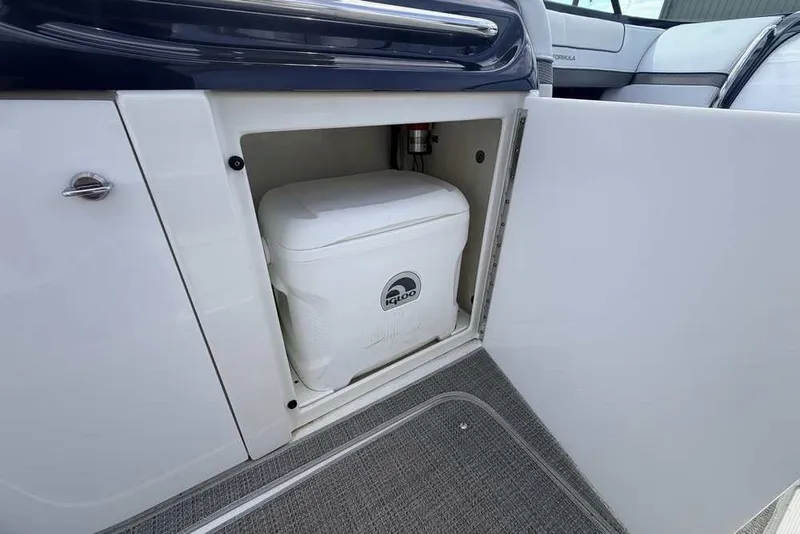 Slide: The Image of 2018 Formula 290 Sun Sport boat storage compartment with Igloo cooler inside. - 22
