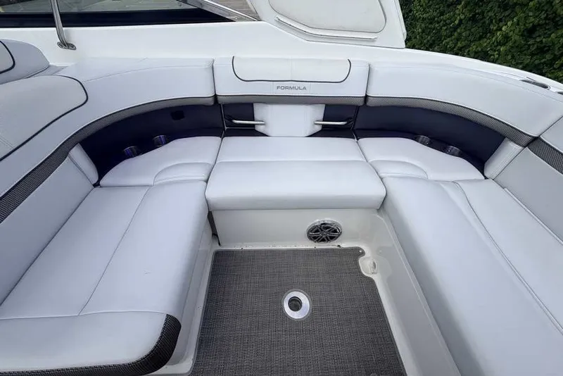 Slide: The Image of 2018 Formula 290 Sun Sport boat interior with white cushioned seating and speaker. - 16