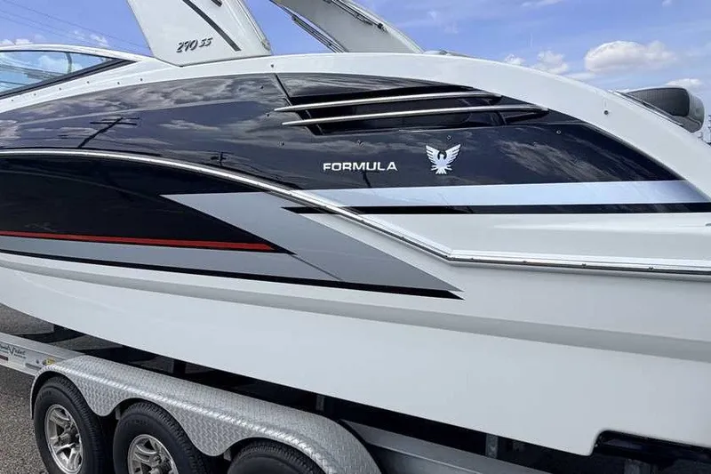 Slide: The Image of 2018 Formula 290 Sun Sport boat on trailer, sleek design with black and white accents. - 3