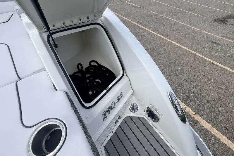 Slide: The Image of 2018 Formula 290 Sun Sport boat storage compartment open, showing interior space. - 13