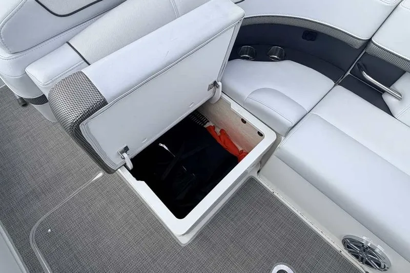 Slide: The Image of Open storage compartment on 2018 Formula 290 Sun Sport boat with cushioned seating. - 17