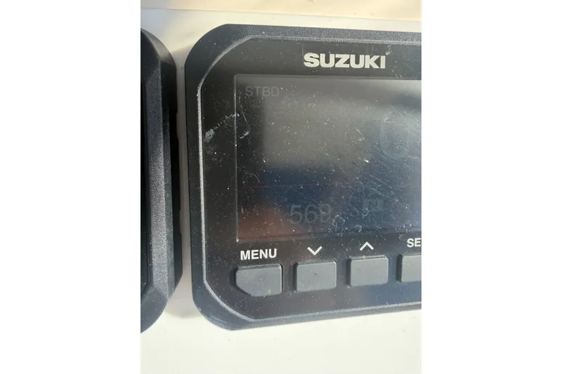 Slide: The Image of Suzuki display panel on 2001 Intrepid 322 Cuddy boat dashboard. - 10