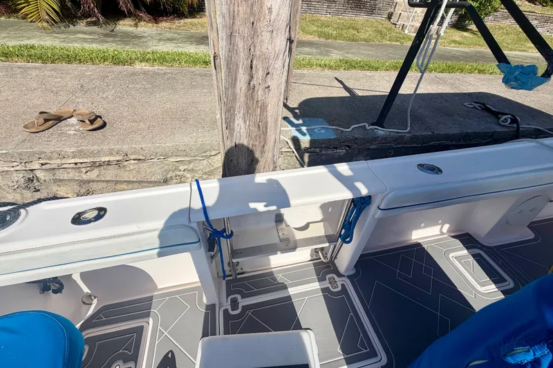 Slide: The Image of 2001 Intrepid 322 Cuddy boat interior with modern flooring and dockside view. - 8