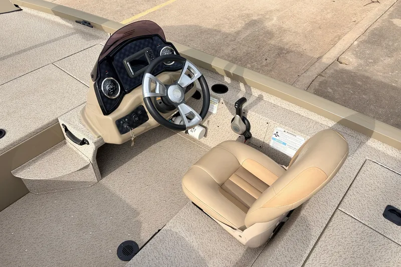 Slide: The Image of 2021 G3 Sportsman 1610 boat interior with steering wheel and beige seat. - 24