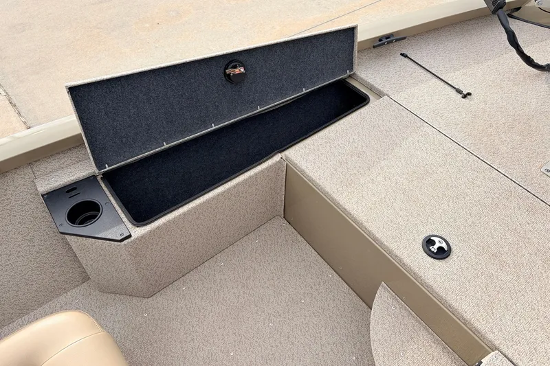 Slide: The Image of 2021 G3 Sportsman 1610 boat interior with open storage compartment and cup holder. - 15
