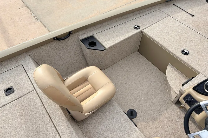 Slide: The Image of 2021 G3 Sportsman 1610 boat interior with beige seating and carpeted flooring. - 21