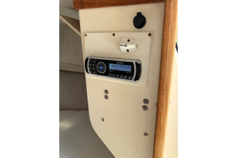 Slide: The Image of 2005 Parker 2520 Modified Vee Sport Cabin interior with radio display and wooden trim. - 21