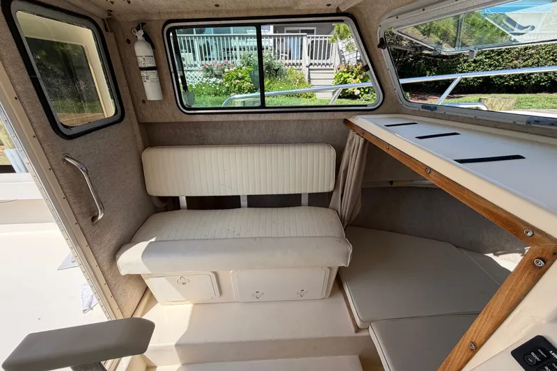 Slide: The Image of Interior of a 2005 Parker 2520 Modified Vee Sport Cabin boat with seating and windows. - 24
