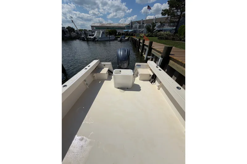 Slide: The Image of 2005 Parker 2520 Modified Vee Sport Cabin boat docked by the water. - 16