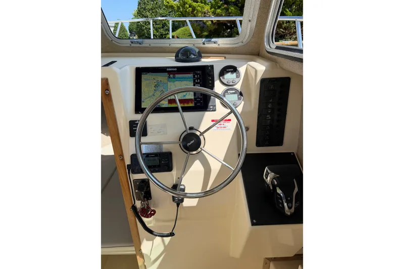 Slide: The Image of Steering wheel and controls of a 2005 Parker 2520 Modified Vee Sport Cabin boat. - 25