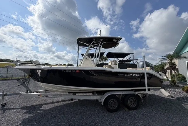 Slide: The Image of 2017 Key West 239 FS boat on trailer under cloudy sky. - 4