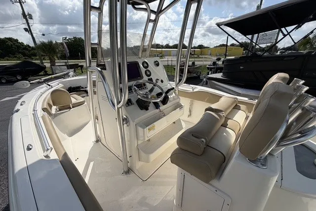 Slide: The Image of 2017 Key West 239 FS boat interior with helm, seating, and controls. - 8
