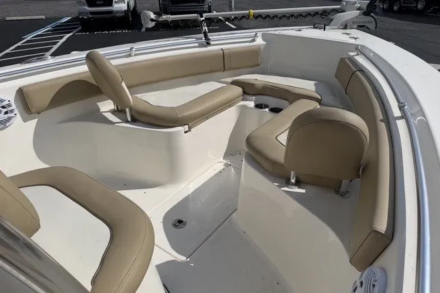 Slide: The Image of 2017 Key West 239 FS boat interior with beige seating and cup holders. - 13