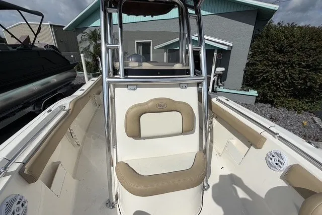 Slide: The Image of 2017 Key West 239 FS boat interior with beige seating and stainless steel frame. - 14