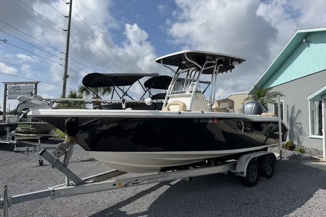 The Image of 2017 Key West 239 FS boat on trailer, parked outdoors under a cloudy sky. - 1