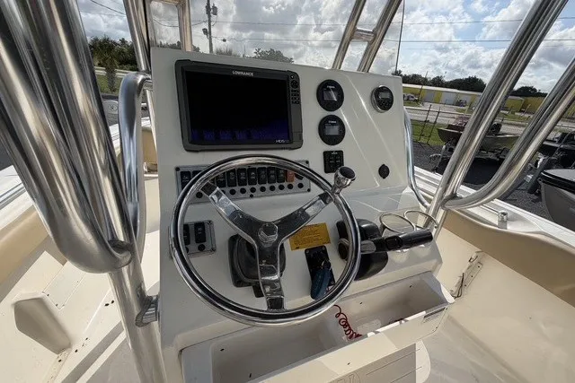 Slide: The Image of 2017 Key West 239 FS boat dashboard with steering wheel and navigation controls. - 11