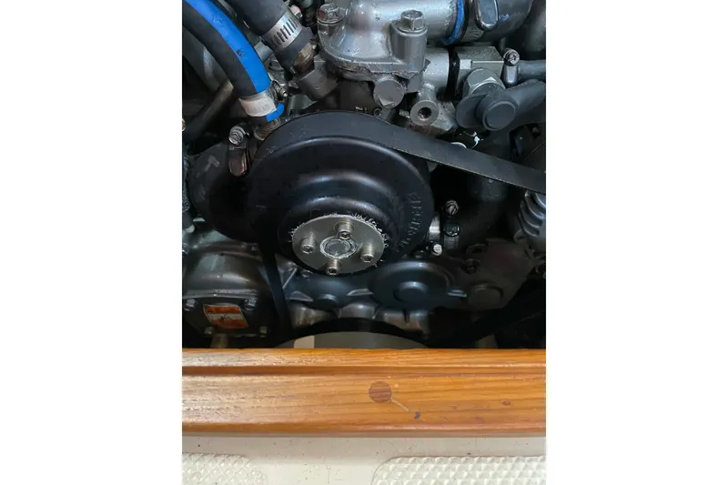 Slide: The Image of Engine compartment of a 2006 Island Packet 440 sailboat, showing mechanical components. - 70
