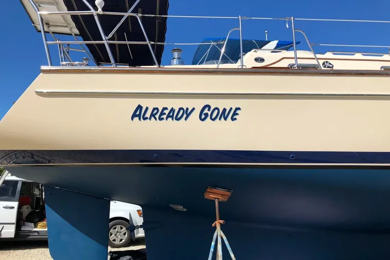 Slide: The Image of Island Packet 440 sailboat, 2006 model, named "Already Gone," on land with blue hull. - 69