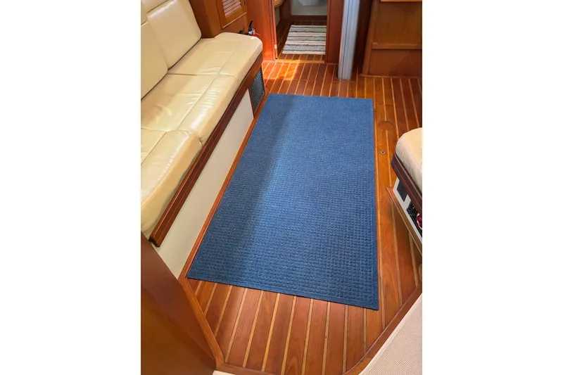 Slide: The Image of Interior of 2006 Island Packet 440 yacht with blue rug and beige seating. - 67