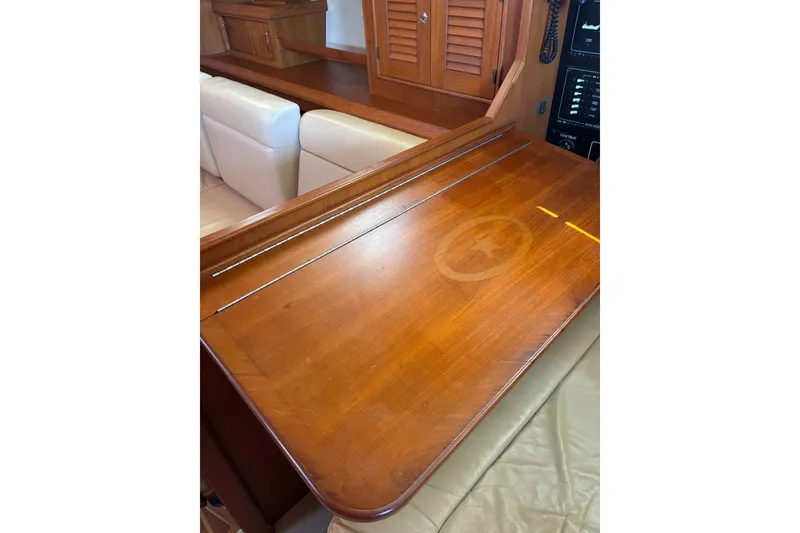 Slide: The Image of Interior of 2006 Island Packet 440 yacht with wooden table and beige seating. - 60