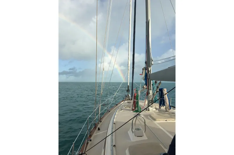 Slide: The Image of Sailing on a 2006 Island Packet 440 yacht with a rainbow over the ocean. - 64