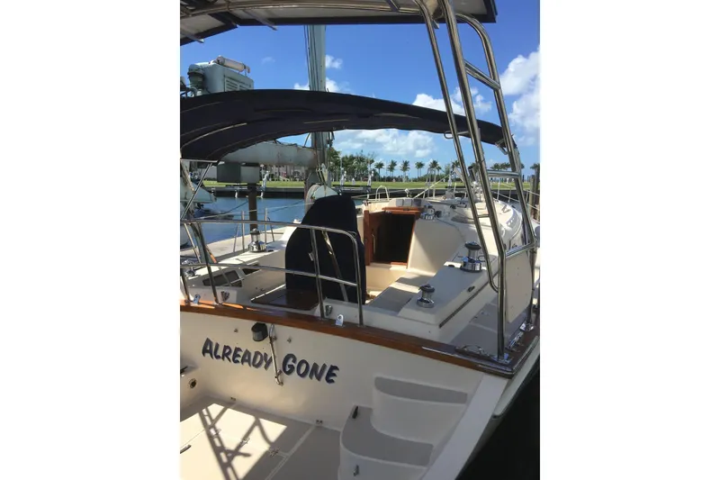 Slide: The Image of 2006 Island Packet 440 sailboat docked, featuring a spacious cockpit and sleek design. - 50