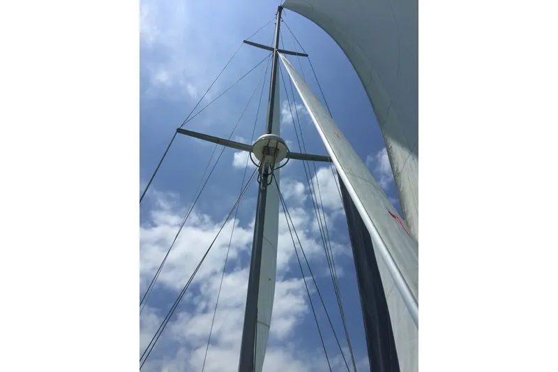 Slide: The Image of Mast and sails of 2006 Island Packet 440 sailboat against a blue sky. - 30
